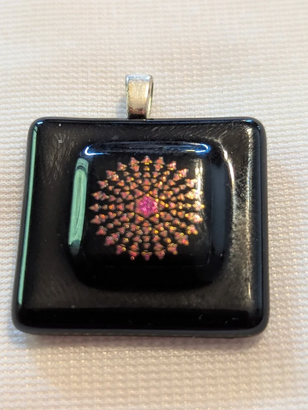 Black Pendant Featuring A Geometric Firework Pattern With Pink Center Handmade